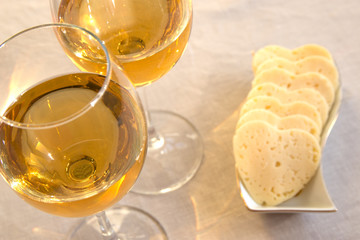 Heart shaped cheese and two glasses of wine. Valentine's Day
