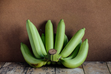 Raw bananas on wood..