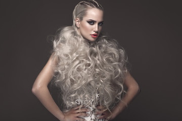 Beautiful girl in art dress with avant-garde hairstyles. Beauty the face. Photos shot in the studio.