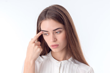 young girl looks away and keeps the finger near the eye