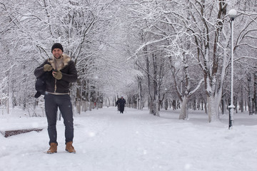 bearded man walking in a winter park