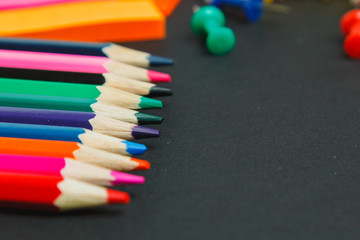 Fototapeta premium Color pencils on dark background