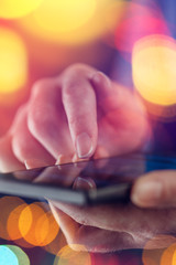 Close up of female finger touching smartphone screen