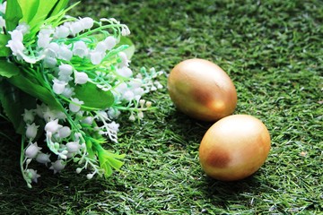 Easter. Painted with Golden eggs on green grass