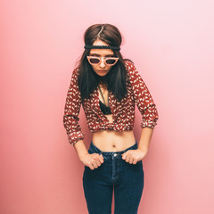 Beautiful woman in fashionable clothing. Hippie style. Shirt and jeans.