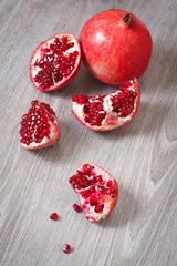 Fototapeta na wymiar Slices of ripe pomegranate on table.