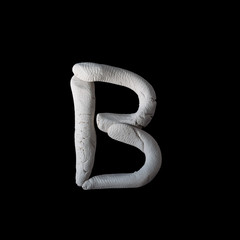Alphabet B mold by clay on brown wooden