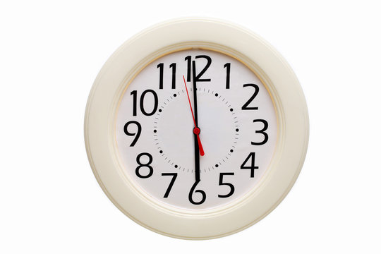 Analog wall clock displaying six o"clock