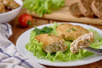 Chicken cutlets with vegetables on a wooden background