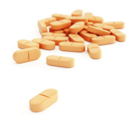Orange pills on white