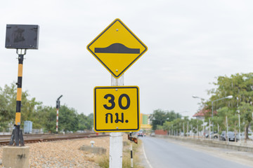 Warning sign of washboard road and Speed limit sign (30km.) in Thailand