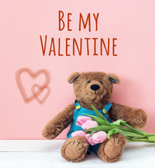 Background on Valentine's Day with a teddy bear and tulips.