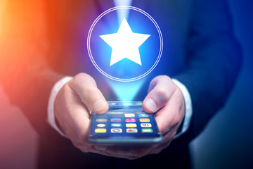 Businessman hand holding mobile phone with favorite star icon