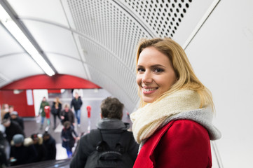 Young woman standing at the escalator in Vienna subway