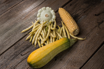 vegetables  green beans, corn, zucchini, squash on old wooden background in rustic style - 136011300