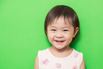Happy asian girl smiling on green background