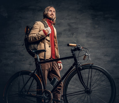 A man posing with bicycle.