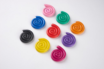 Set of nine plasticine colorful spirals isolated on white background.