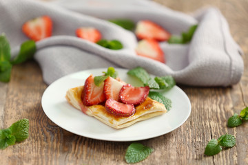Sweet tasty pastry with fresh strawberries on plate
