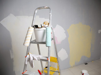 Ladder and set of tools for repair in empty room