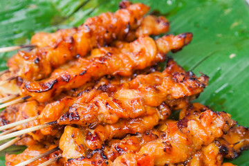 chicken grilled in Thai style on banana leafs.