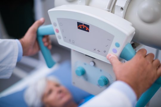 Radiologist using x-ray machine in hospital