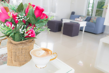 Cup of coffee on the table with flower in cafe, Joyful with coffee time concept.