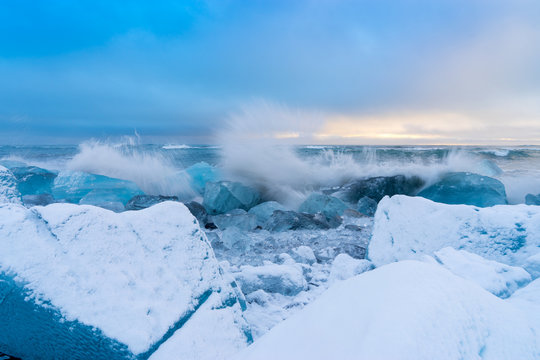 An iceberg being broken by the waves Iceland