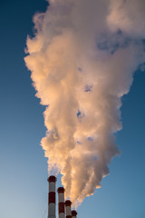 environmental pollution concept, pipes and smog on blue sky background