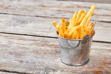 Metal bucket with french fries.