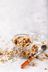 Homemade granola with nuts and seeds in glass jar for healthy breakfast
