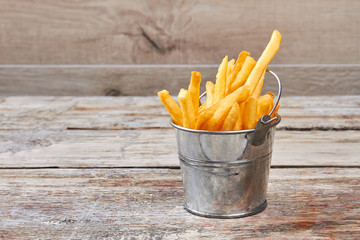 French fries in metal bucket.