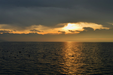 Sunrise over the lake. The mountainous landscape.