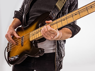 Fototapeta na wymiar Bassist plays bass guitar.