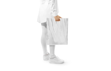 Blank grey plastic bag mockup holding hand. Woman hold gray carrier sac mock up. Plain bagful...