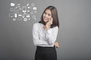 Beautiful business Woman using smartphone on grey background