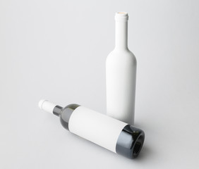 Two wine bottle are standing on gray background
