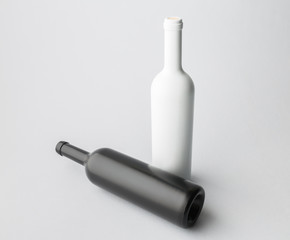 Two wine bottle are standing on gray background