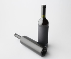 Two wine bottle are standing on gray background