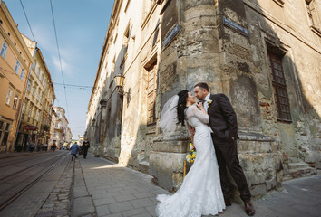 Romantic newlyweds on the street in the sunny Lviv