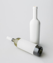 Two wine bottle are standing on gray background