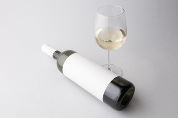 Wine bottle and wine glass on a gray background