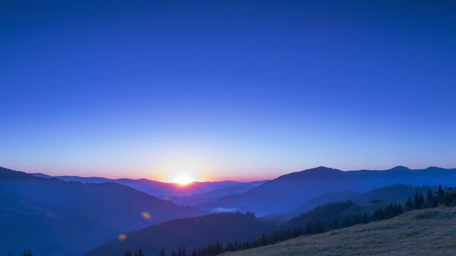 Old Carpathian mountains. Summer. Cloudless sky. Morning mist in the valley. Dawn. Time lapse