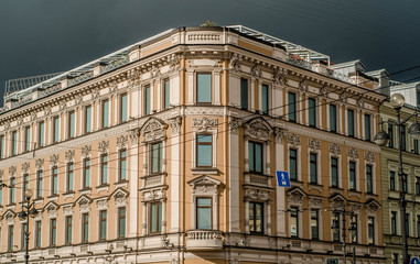 Fototapeta na wymiar A picture of a vintage old classic typical european urban house facade building with windows and a storm sky above