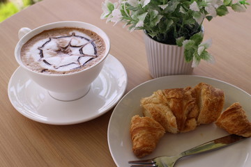 croissant and coffee on the table