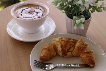 croissant and coffee on the table