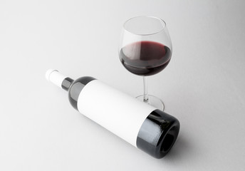 Wine bottle and wine glass on a gray background