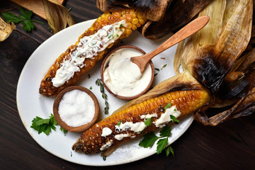 Grilled corn with herbs and sauce © voltan