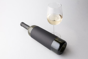 Wine bottle and wine glass on a gray background