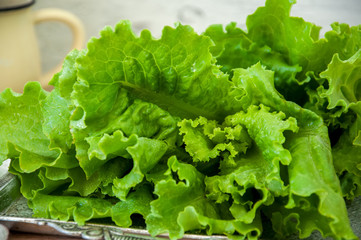 Fresh salad on a vintage tray on wooden background